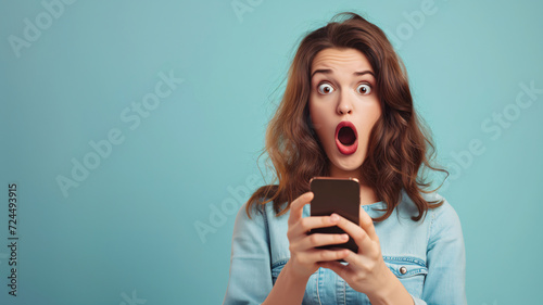 shocked girl using a mobile phone photo