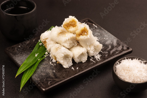 Putu Bumbung or Kue Putu Bambu is a Cake made from Rice Flour and Formed Using Bamboo Molds Filled with Palm Sugar. photo