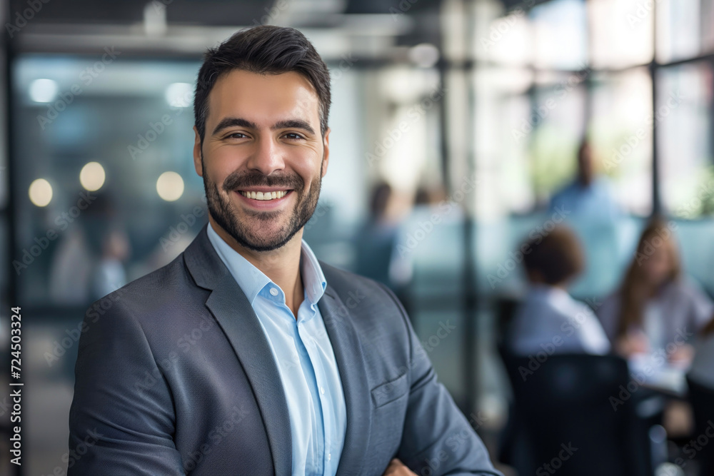 Confident portrait businessman smilling in a suit in the office Confident portrait businessman smilling in a suit in the office