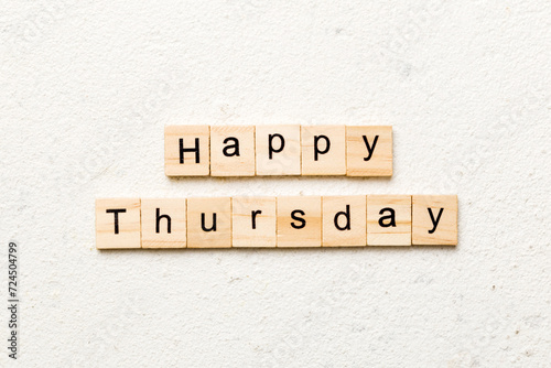 Happy thursday word written on wood block. Happy thursday text on cement table for your desing, concept photo
