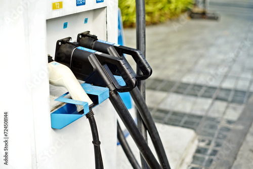 Row of EV fuel nozzles at EV Car Charging station, Blur background with copy space