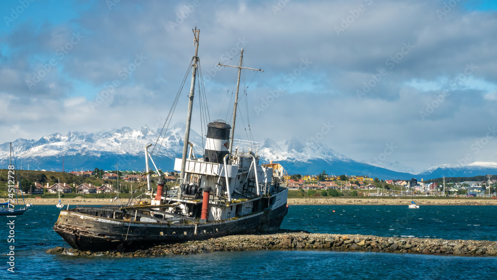 Old fishing boat wreckage stranded on the shores of the port city of Ushuaia, Tierra del Fuego, Patagonia, Argentina