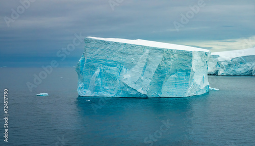 Beautiful flat top sculpted iceberg with various tones of blue, green and white, Paradise Bay, Gerlach Straight, Antarctica