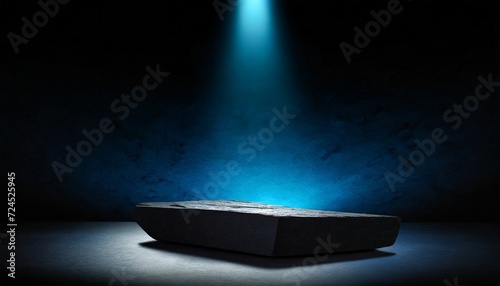 black stone platform podium with blue color light on black background for product display presentation and advertising copy space