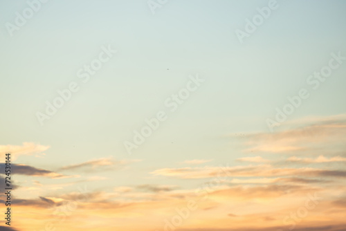 A beautiful sky tinted by the sun leaving vibrant shades of gold  pink  blue and multicolored. Clouds in the twilight evening and morning sky. Cloudy sky background in the evening and during the day.