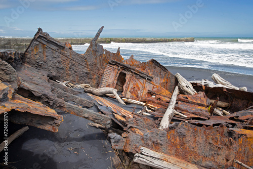  S.S. Waitangi shipwreck. Rusty shipwreck at Mana Bay New Zealand. Patea. Taranaki. Tasman Sea. Coast and Beach. Lava sand. © A