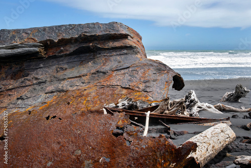  S.S. Waitangi shipwreck. Rusty shipwreck at Mana Bay New Zealand. Patea. Taranaki. Tasman Sea. Coast and Beach. Lava sand. photo