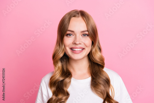 Photo portrait of young gorgeous stunning woman wavy brown hair sweet smile wearing trendy white t shirt isolated on pink color background © deagreez