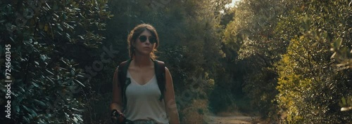 a woman on a hike gets closer and closer to the camera photo