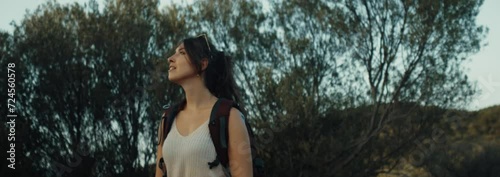 A woman look something beautiful during hike.