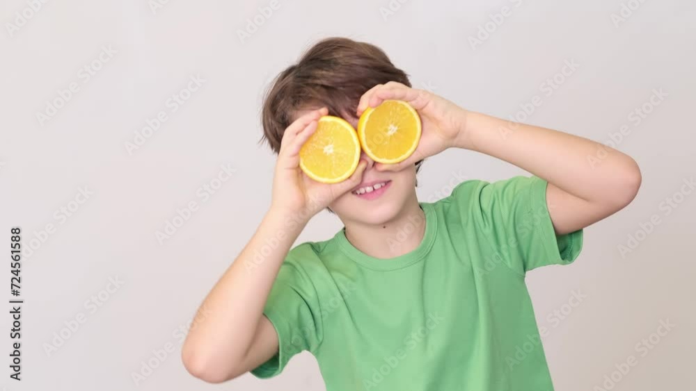 child playfully uses slices of orange eyes. innocence in this act reflects pure enjoyment of simple things. With orange slices over eyes, child's imagination turns a snack into a game, showcasing child playfully uses slices of orange eyes. innocence in this act reflects pure enjoyment of simple things. With orange slices over eyes, child's imagination turns a snack into a game, showcasing