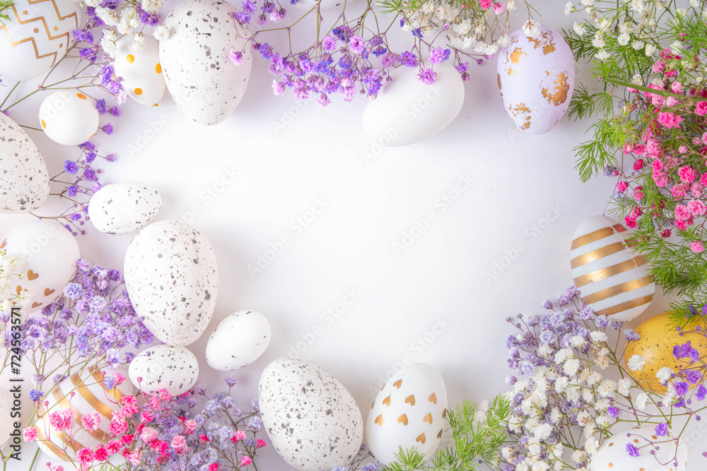 Happy Easter greeting card background with easter eggs and spring flowers. Easter holiday flat lay composition with copy space for text