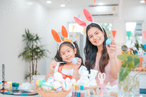 Mother and daughter are painting Easter eggs and enjoy to preparing for decorating home during Easter festival, event or celebration. Creativity family indoor activity, Christianity religion lifestyle