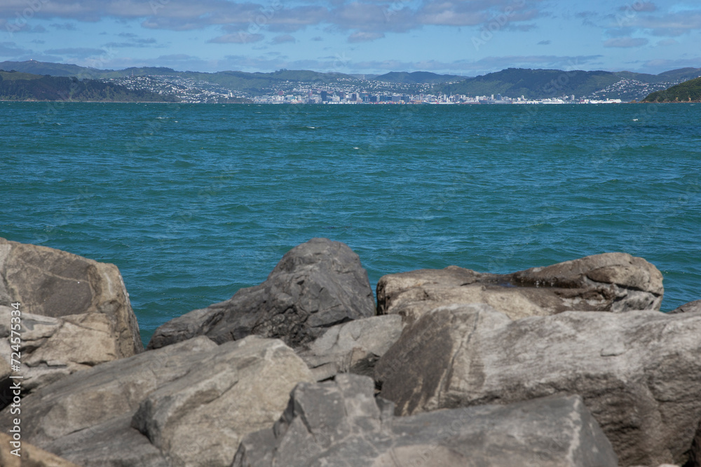 Rocks. Eastbourne New Zealand. Wellington Harbour. Coast. Rona Bay wharf.