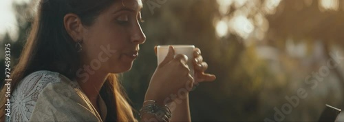 Woman remote working at home, she drinks her coffee and smiling.