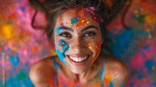 Happy sunny beautiful woman female teenager celebrating holi festival in spring, summer day outdoor in green park with light leaks and colorful powder. International spring happy holi holiday concept © Mujahid