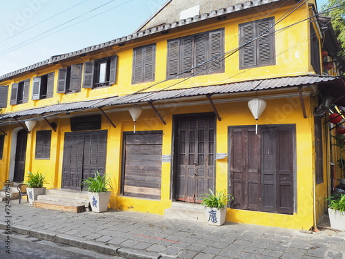 Yellow building with brown doors and shutters in Hoi An Ancient Town © Maria
