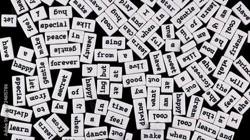 Black and white composition. Words in English on rectangular small plastic blocks of white colour. Series of words in minimalist style. Black background.