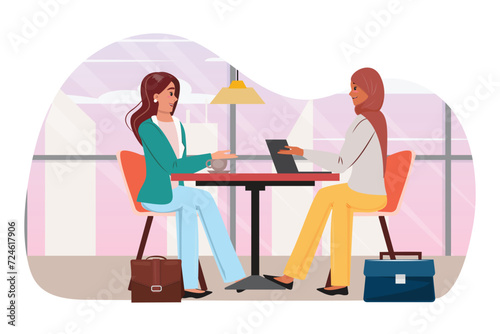 Two businesswomen, one muslim and one white, engage in dialogue, fostering diversity and collaboration