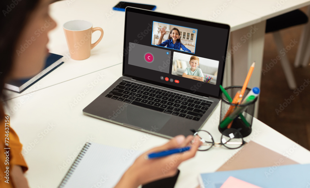 Teacher with computer having video conference chat with students Teacher with computer having video conference chat with students