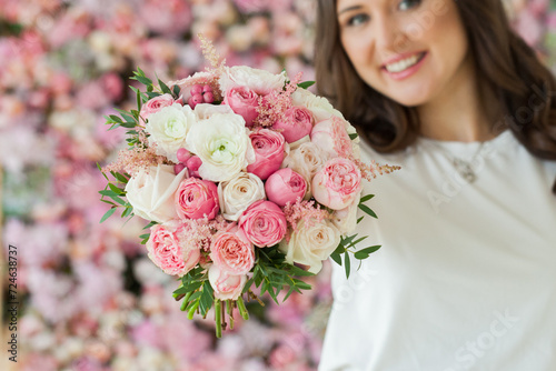 Beautiful pink and white flower bouquet in female hand