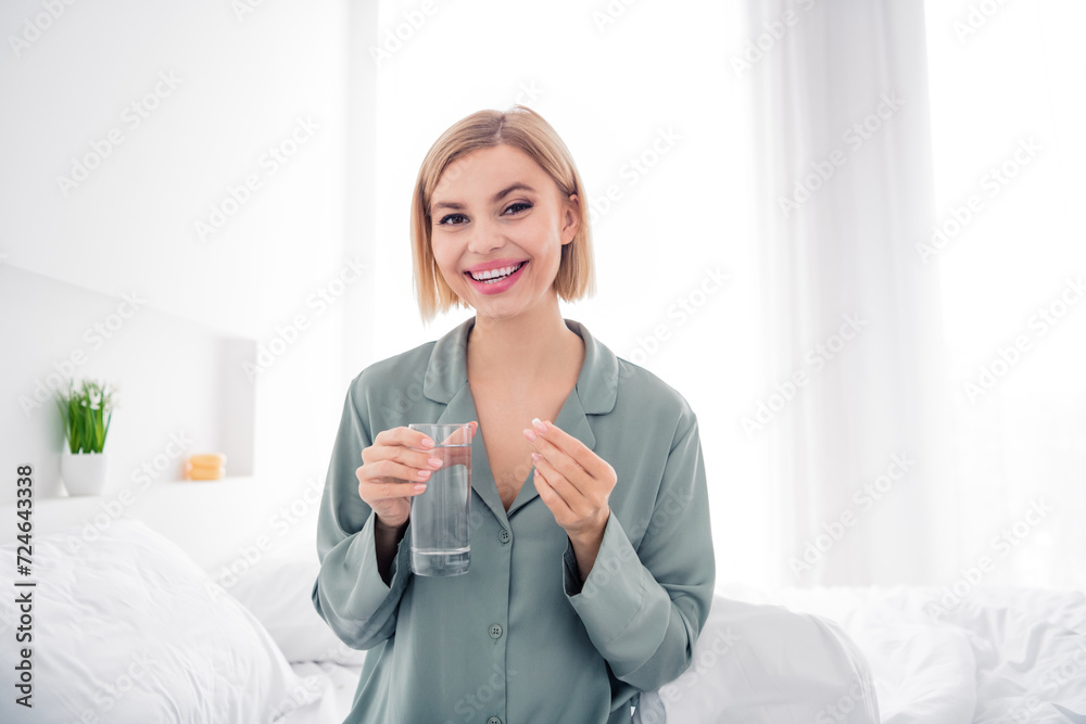 Photo portrait of lovely blonde young lady sit bed water glass medicine wear trendy gray sleepwear comfortable bedroom daytime Photo portrait of lovely blonde young lady sit bed water glass medicine wear trendy gray sleepwear comfortable bedroom daytime