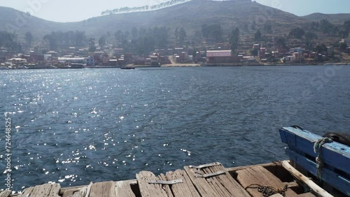 wooden barges transporting cars and buses across the strait of Tiquina at lake Titicaca in the high altitude of the Andes mountains in Peru on the way to La Paz. photo