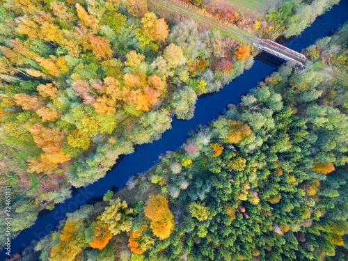 Aerial view of railway bridge over the Masurian Canal in autumn colors, Mazury, Poland