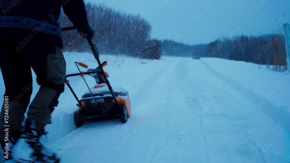 A Man is Using a Snow Blower to Clear the Road - Static Shot A Man is Using a Snow Blower to Clear the Road - Static Shot