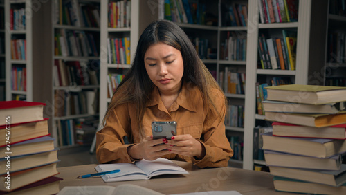 Valokuva Asian girl student sitting in library write doing homework frustrated young woma