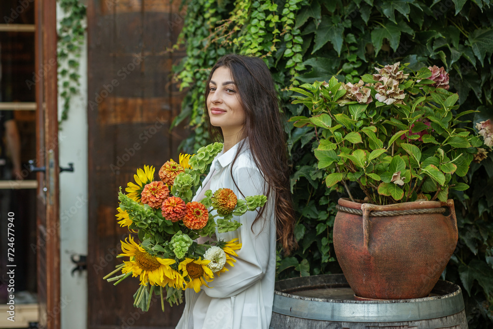Young Woman with Autumnal Flower Bouquet