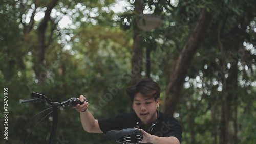 Wallpaper Mural Healthy and active lifestyle, going to work on eco transport. Smiling attractive millennial male employee in glasses with bag and cup of takeaway coffee, moving bike in city park in summer, outdoor Torontodigital.ca