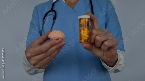 Doctor holds psycho neurological pills for brain in hands. Dementia alzheimer disease photo