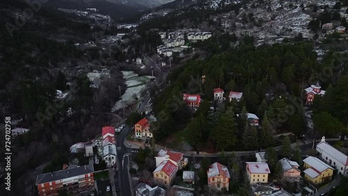 ski resort in winter, Cinematic drone view above a moaintain village coverd by snow