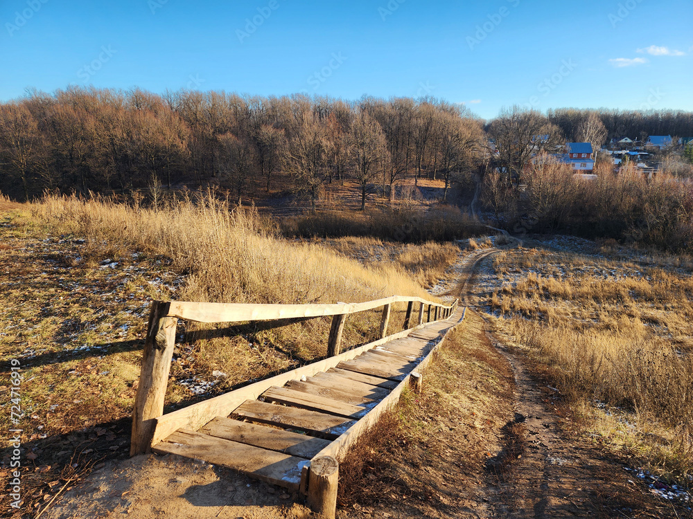 Long old wooden staircase in the village. Rural lifestyle. Long old wooden staircase in the village. Rural lifestyle.