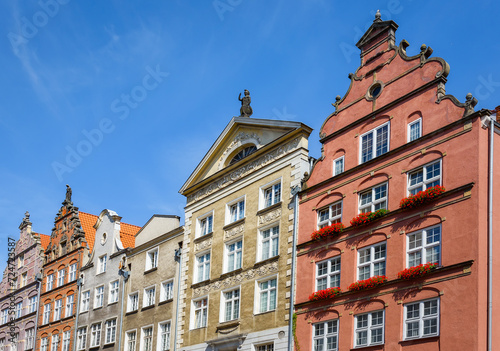 Facade of beautiful typical colorful houses on Dluga street (Dlugi Targ square) in old historical town centre on a sunny summer day, Gdansk, Poland photo