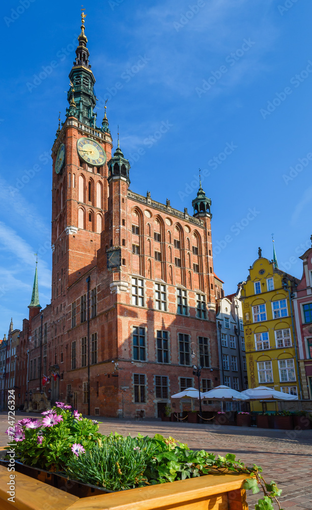 Beautiful architecture of the old town in Gdansk with city hall and Artus court, Poland. A walk through the city on a sunny summer day