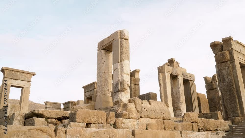 Scenic ruins of the Hadish Palace (the Palace of Xerxes) on blue sky background in Persepolis, Iran. Ancient Persian city. Persepolis is a popular tourist destination of the Middle East. Scenic ruins of the Hadish Palace (the Palace of Xerxes) on blue sky background in Persepolis, Iran. Ancient Persian city. Persepolis is a popular tourist destination of the Middle East.