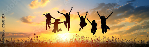 group of people jumping high against the sunset