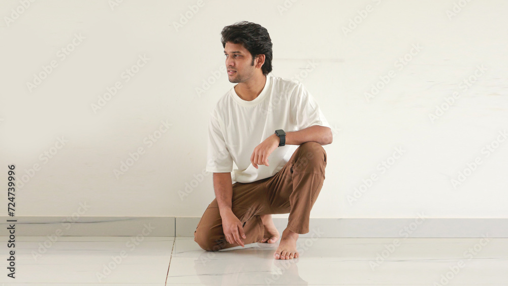 Fototapeta premium Indian man half sitting in floor