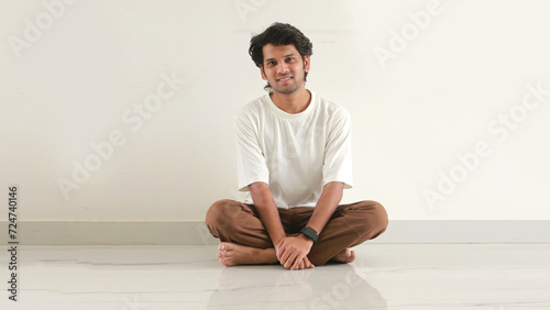 Indian man sitting in floor with smile face