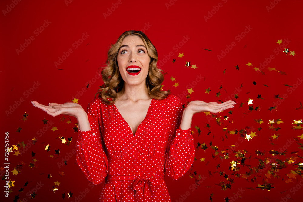 Photo of gorgeous cheerful impressed girl raise hands look empty space flying star shape confetti isolated on red color background Photo of gorgeous cheerful impressed girl raise hands look empty space flying star shape confetti isolated on red color background