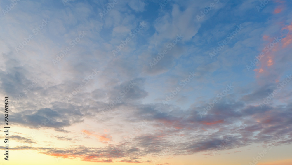Beautiful sunset sky. Sunset sky panorama with Cirrus clouds. Panorama of the blue-pink sunset sky - the gentle sky on the horizon. Natural sky, amazing and cinematic sunset texture background