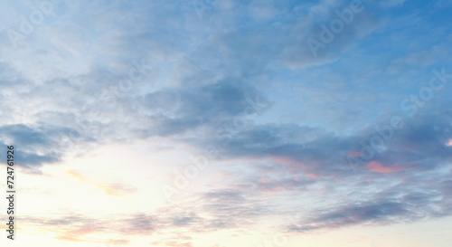 Beautiful sunset sky. Sunset sky panorama with Cirrus clouds. Panorama of the blue-pink sunset sky - the gentle sky on the horizon. Natural sky, amazing and cinematic sunset texture background