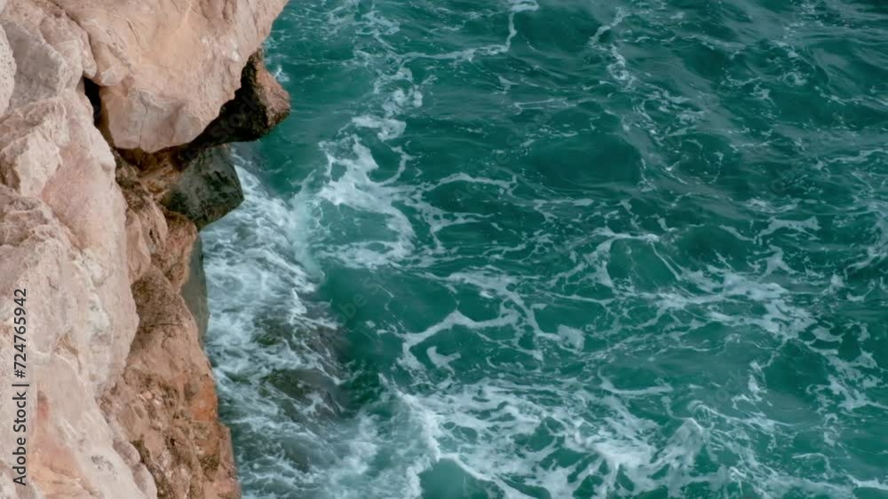 Big waves crashing against rocky shore. Mediterranean sea water splashes. Benidorm, Spain Big waves crashing against rocky shore. Mediterranean sea water splashes. Benidorm, Spain