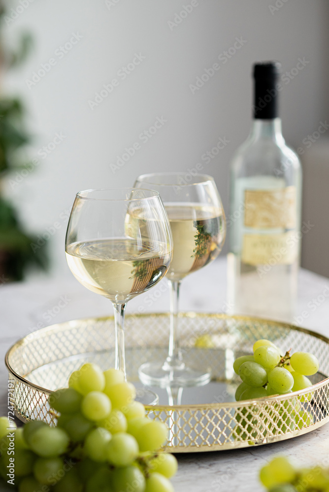 two glasses of white wine on a beautiful tray