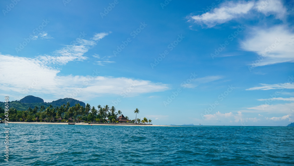 Beautiful Tropical beach at Koh Mook (Koh Muk) island, Thailand. Hotel and tropical beach with palm trees and soft white sand, and a turquoise colored ocean.