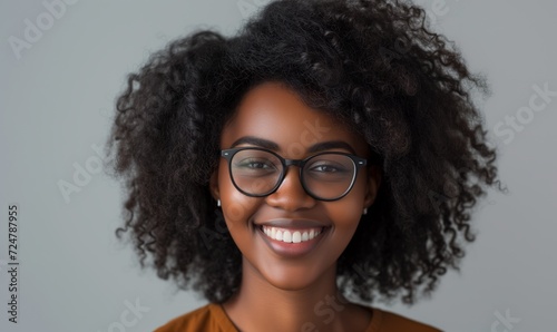 Head shot happy portrait African girl in glasses - millennial curly woman with healthy white toothy smile