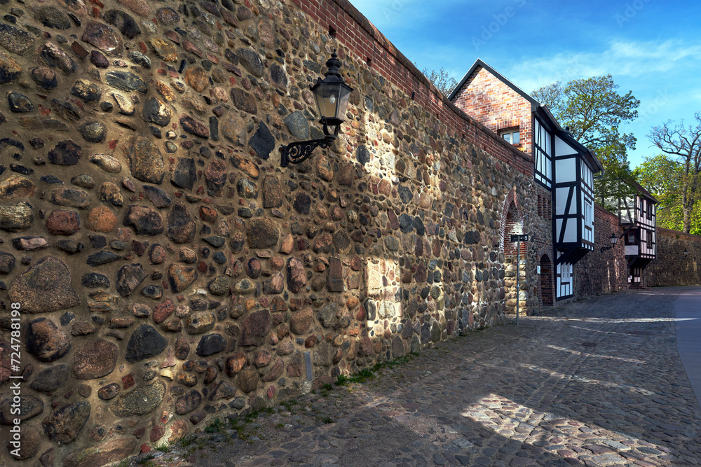 Stone, medieval walls with a historic, multi -story house in the city of Neubrandenburg