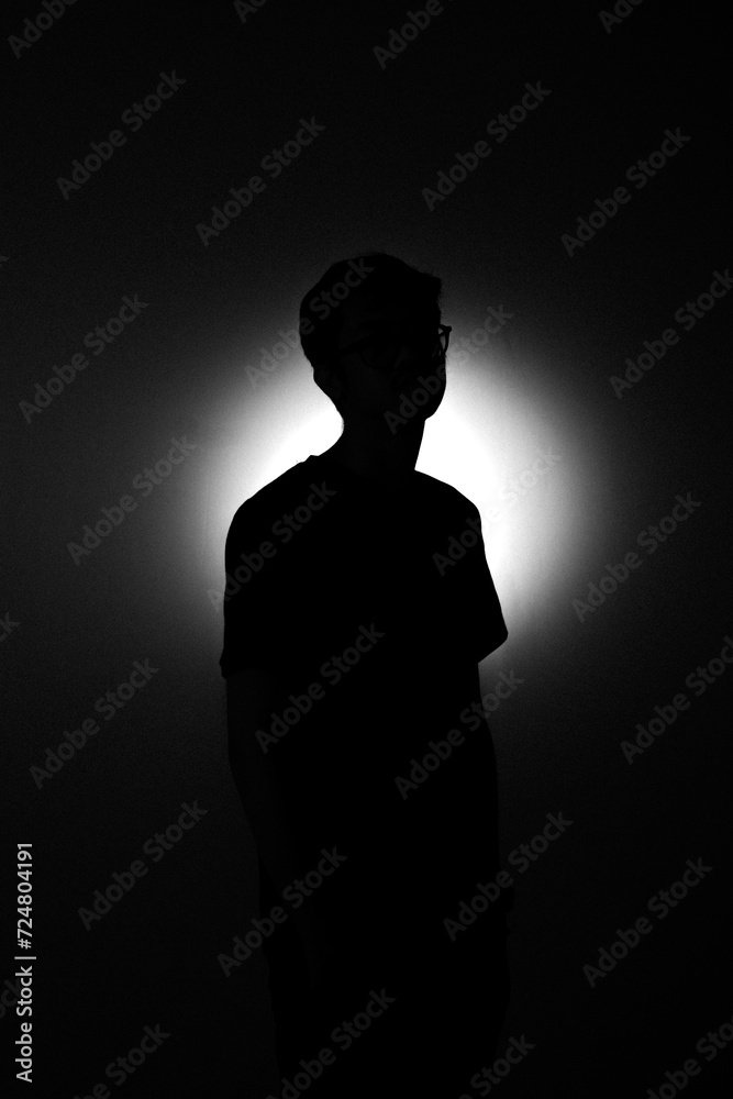 circle light with silhouette of a man 